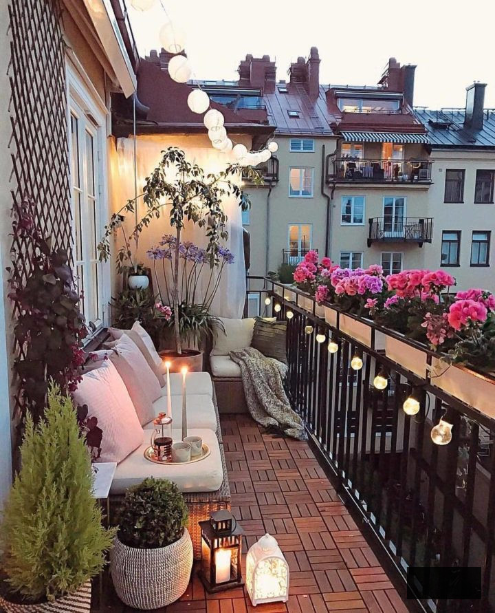 small balcony with decorative lighting and plants