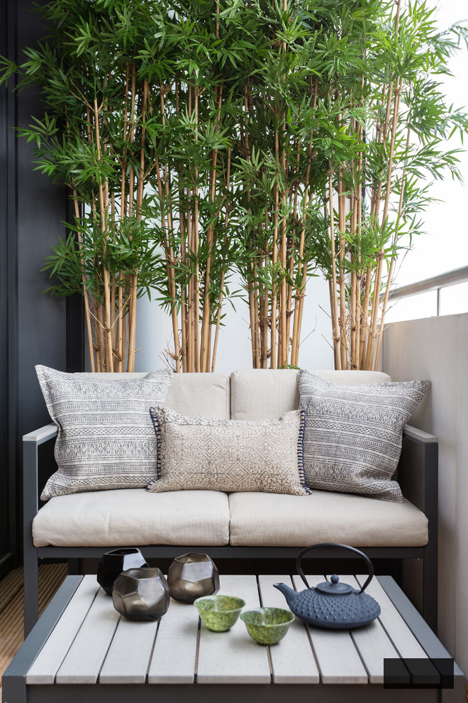 balcony trees with a small sofa as a sitting area
