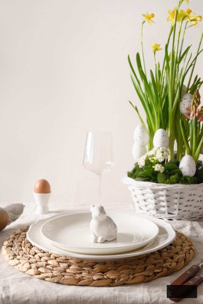 Spring Easter table setting with organic eggs, bunny and blossom flowers