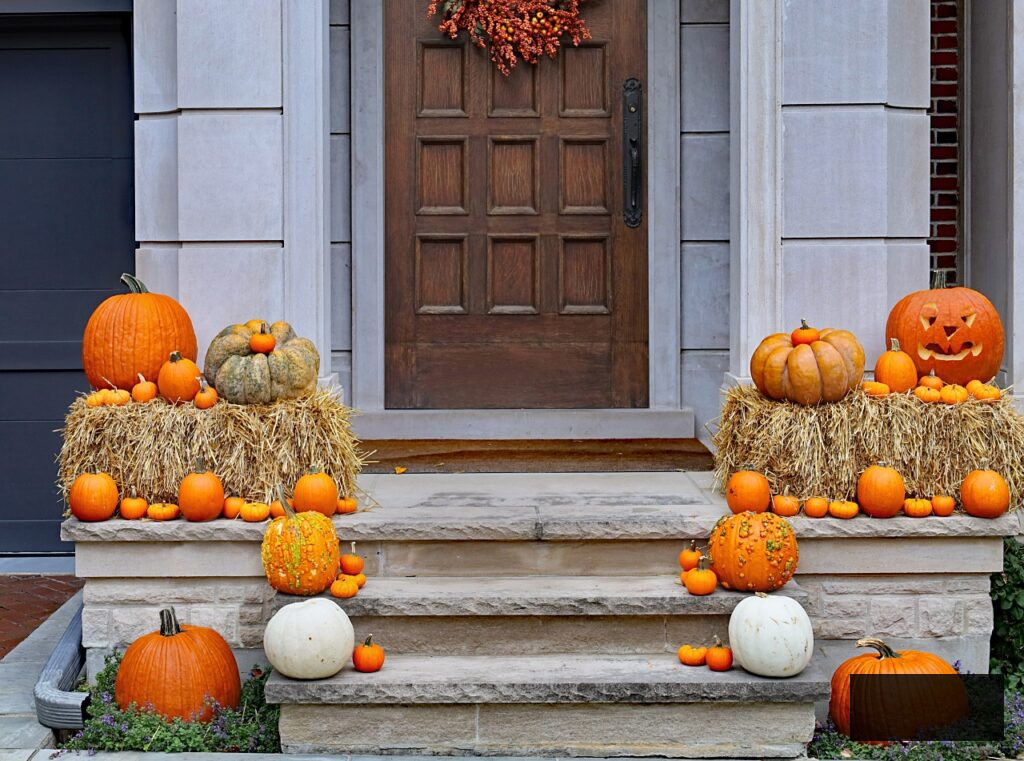 Pumpkins and hay bales on the front porch - autumn decoration
