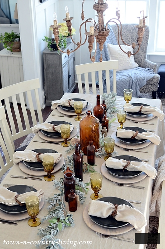 Linen table setting with vintage amber bottles