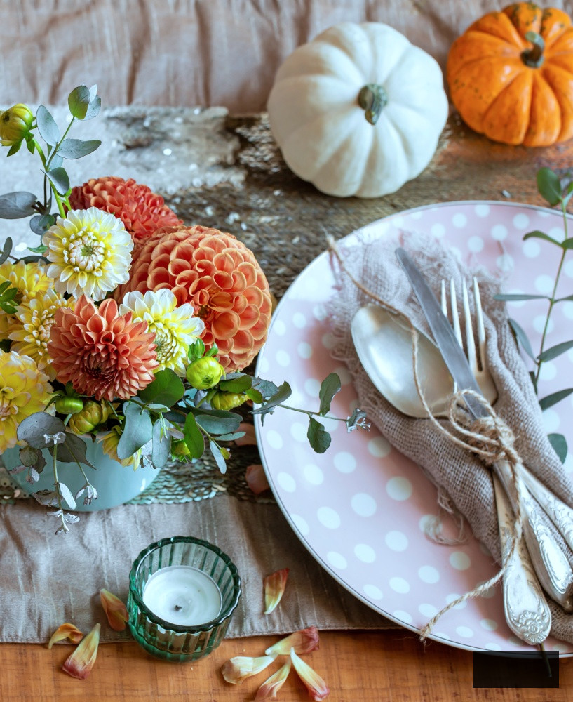 Soft toned autumn flowers on the dinner table