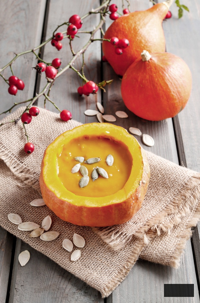 Pumpkin soup presented in a hollowed-out pumpkin
