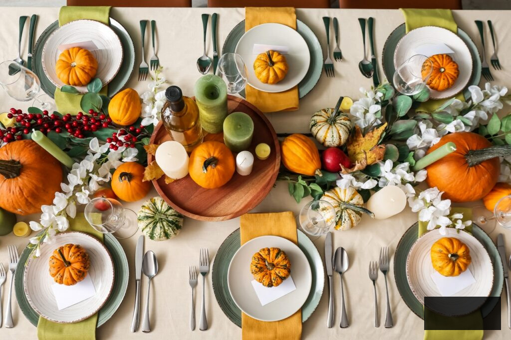 Autumn table setting with fresh pumpkins and flowers