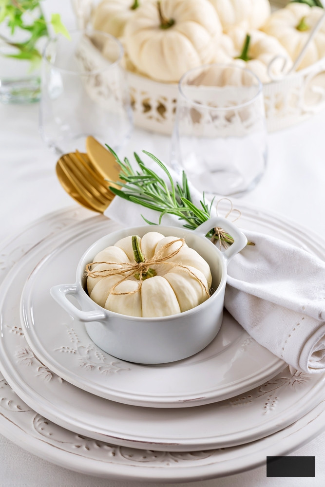 White place setting with baby boo pumpkin