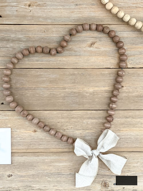 Looking for easy ways to decorate for Valentine's Day? These DIY Wood Bead Valentine Wreaths turn dollar store items into 3 pretty wreaths.