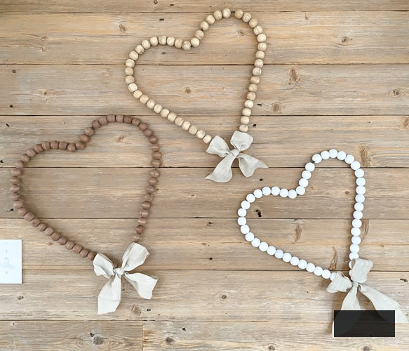 Looking for easy ways to decorate for Valentine's Day? These DIY Wood Bead Valentine Wreaths turn dollar store items into 3 pretty wreaths.