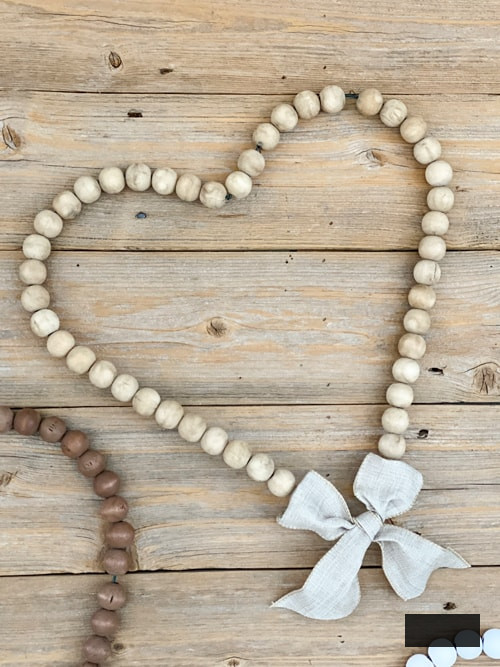 Looking for easy ways to decorate for Valentine's Day? These DIY Wood Bead Valentine Wreaths turn dollar store items into 3 pretty wreaths.