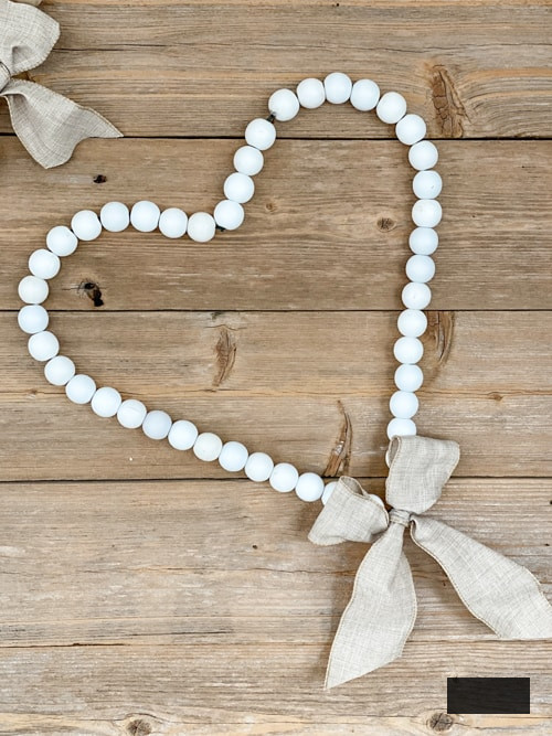 Looking for easy ways to decorate for Valentine's Day? These DIY Wood Bead Valentine Wreaths turn dollar store items into 3 pretty wreaths.
