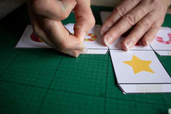 peeling the tape from double-sided sticky tape to stick a net together