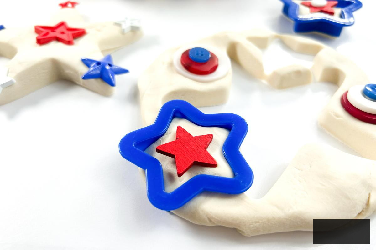 Playdough invitation to engage for the 4th of July featuring stars in red, white, and blue.