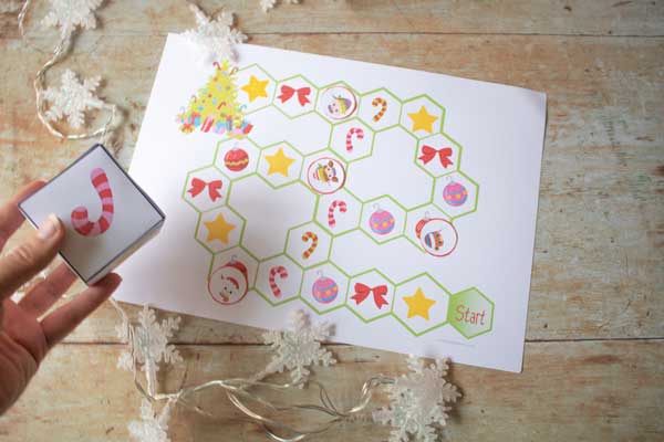 taking turns rolling the printable dice to advance to different squares on the board