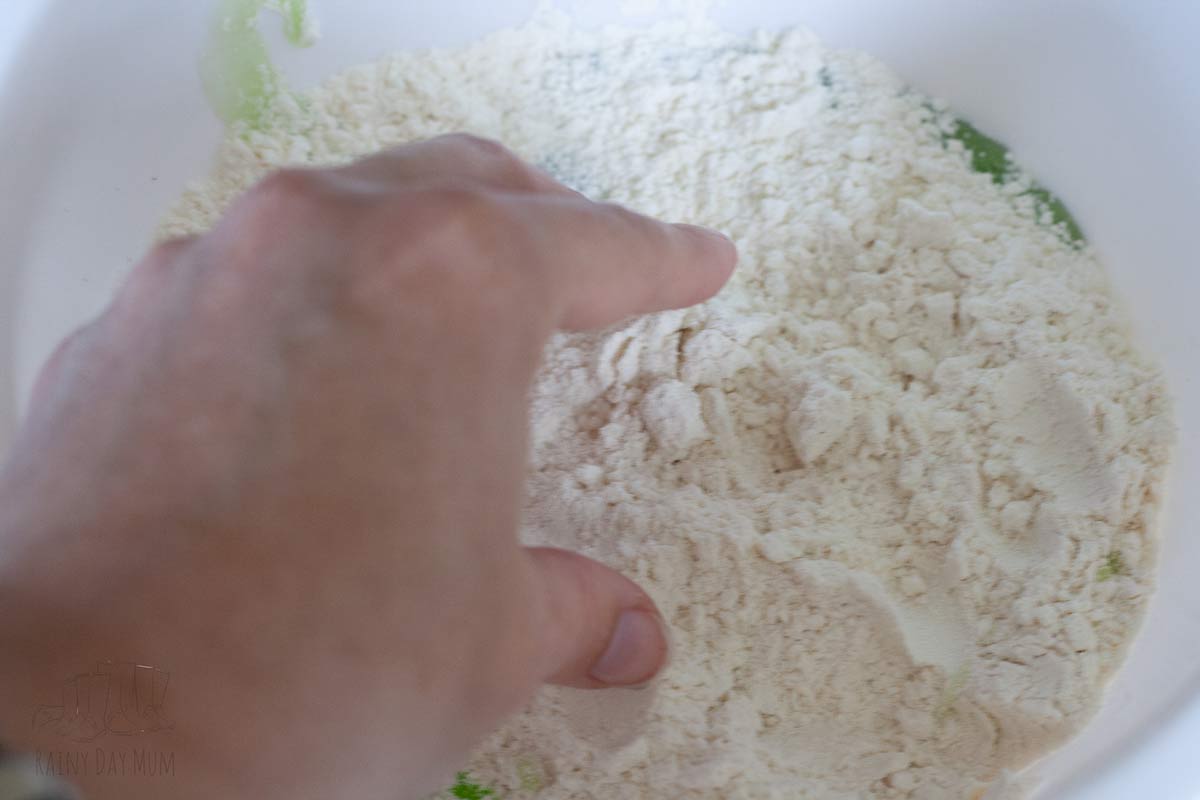 flour and dishwashing liquid in a bowl to create apple scented playdough.