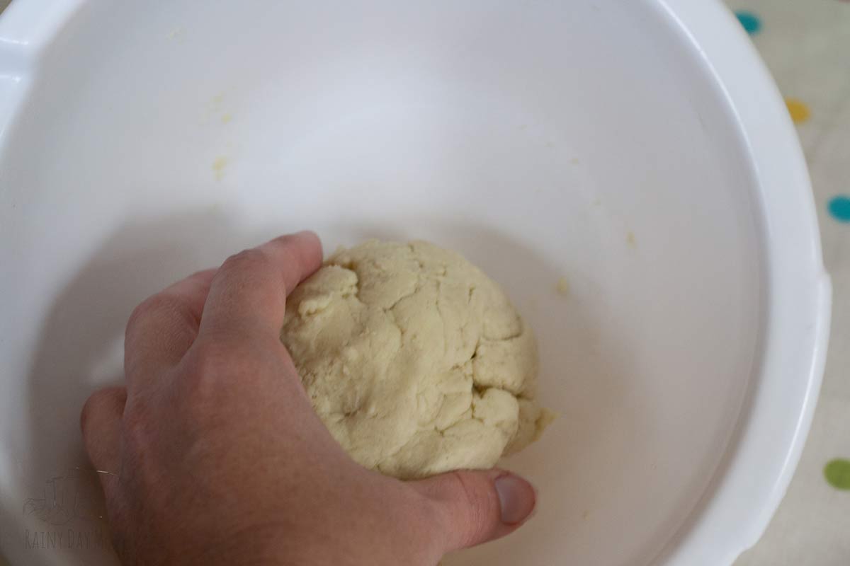 Combining the homemade playdough in a bowl.