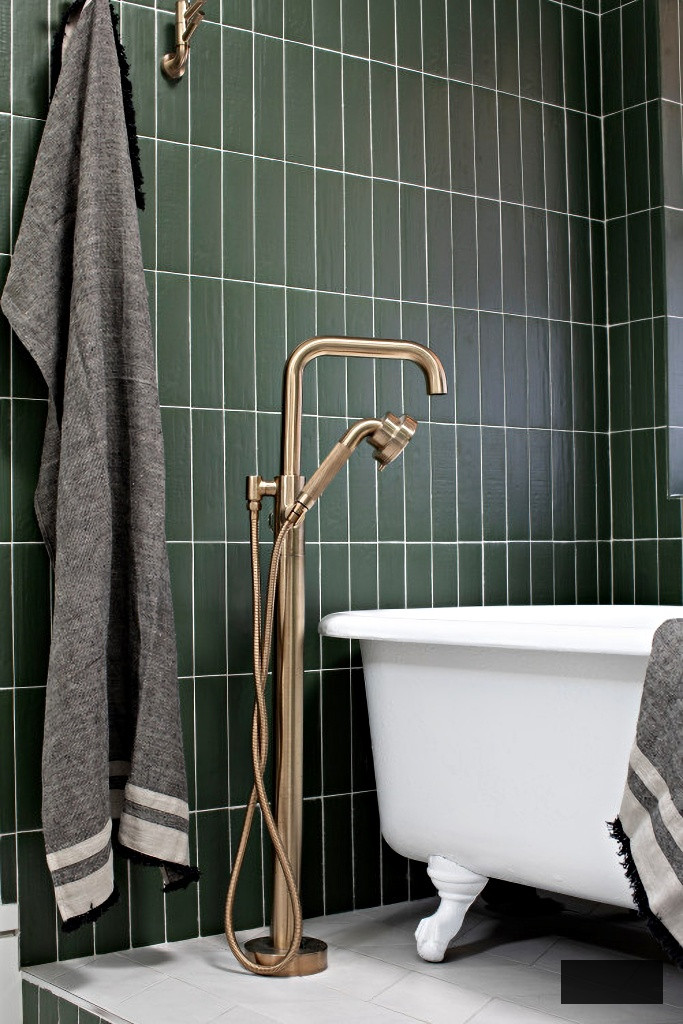 dark green tile and white claw foot tub