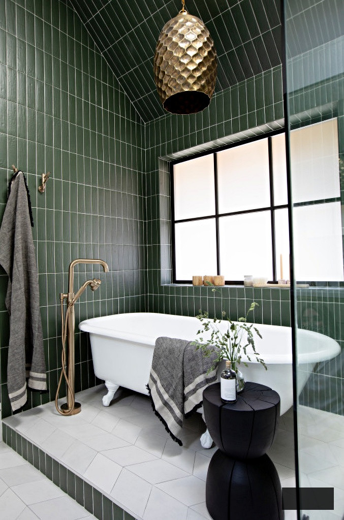dark green tile and white claw foot tub