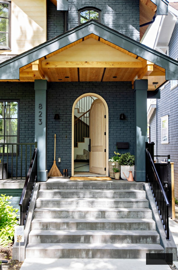 wooden arched door on Tudor home porch