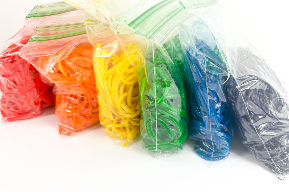 Bags containing rainbow-dyed spaghetti ready for activities
