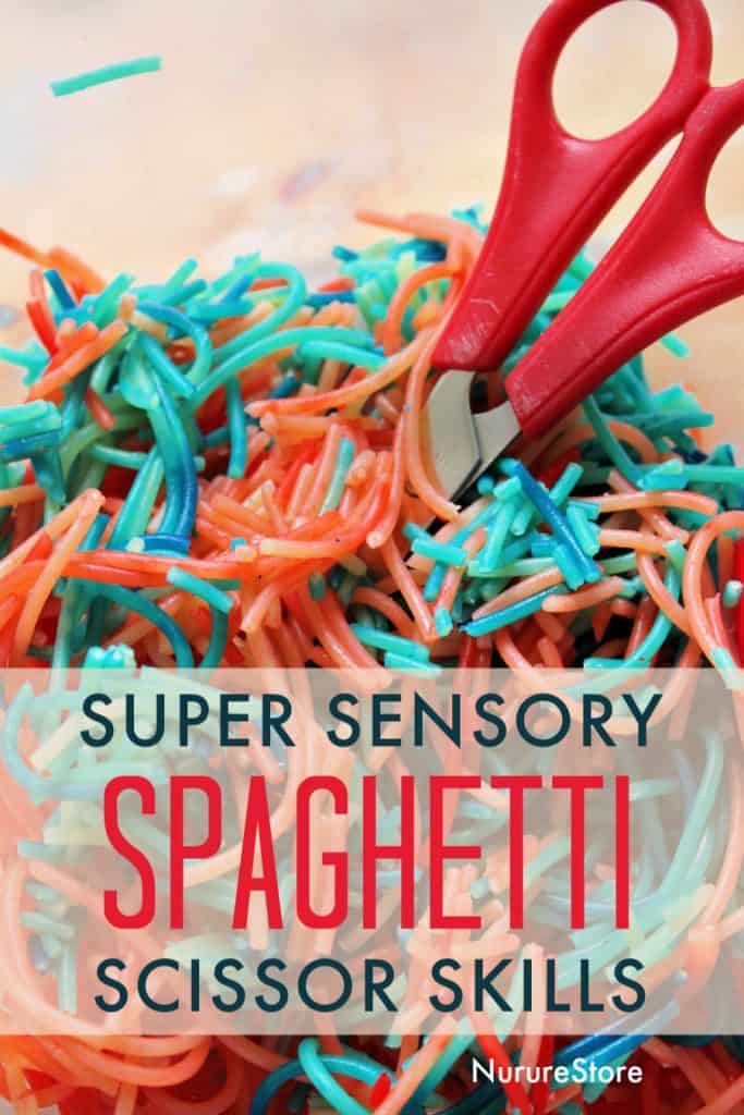 Image of dyed noodles alongside scissors for a sensory bin and cutting skills activity for preschool-age children