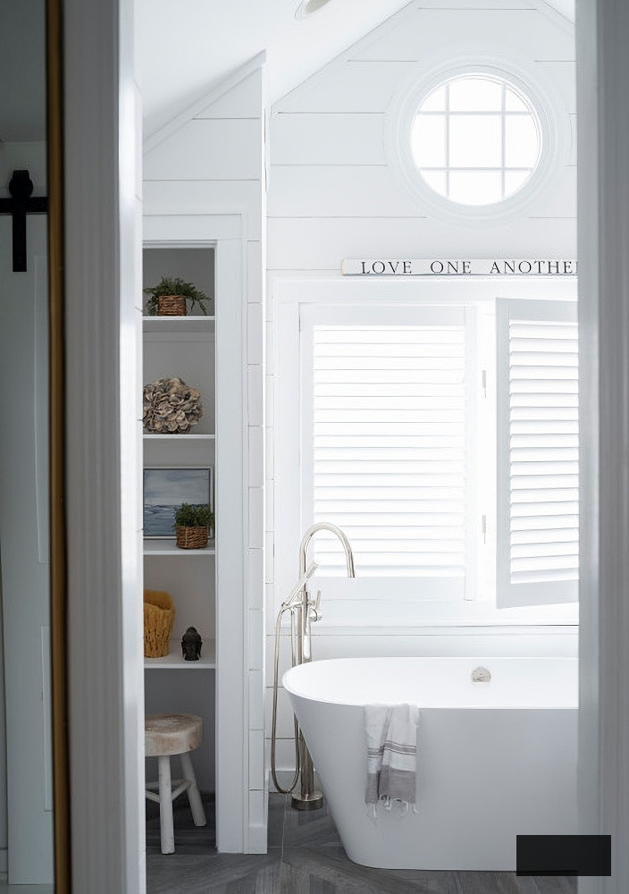 white coastal bathroom with freestanding tub