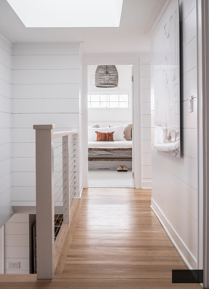 Bright and spacious hallway with white shiplap walls