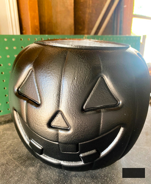 Craft chic Halloween decorations with a DIY Pottery Barn Jack-O-Lantern replica. Achieve the upscale appearance for under $5 using plastic buckets, paint, and LED candles.