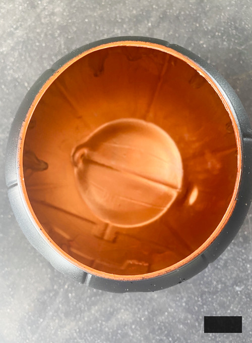 Craft chic Halloween decorations with a DIY Pottery Barn Jack-O-Lantern replica. Achieve the upscale appearance for under $5 using plastic buckets, paint, and LED candles.