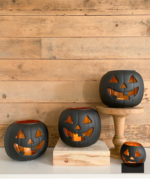 Craft chic Halloween decorations with a DIY Pottery Barn Jack-O-Lantern replica. Achieve the upscale appearance for under $5 using plastic buckets, paint, and LED candles.