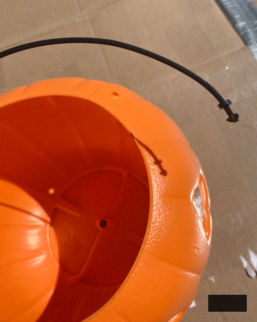 Craft chic Halloween decorations with a DIY Pottery Barn Jack-O-Lantern replica. Achieve the upscale appearance for under $5 using plastic buckets, paint, and LED candles.