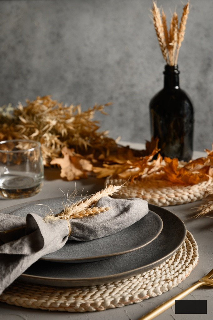 Autumn table setting with dry yellow oak leaves