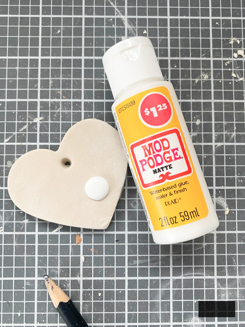 Create a charming DIY Heart Garland using air dry clay, book pages, and stain. This easy craft adds a vintage touch to your home decor for any season.
