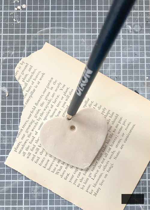 Create a charming DIY Heart Garland using air dry clay, book pages, and stain. This easy craft adds a vintage touch to your home decor for any season.