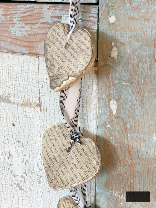 Create a charming DIY Heart Garland using air dry clay, book pages, and stain. This easy craft adds a vintage touch to your home decor for any season.