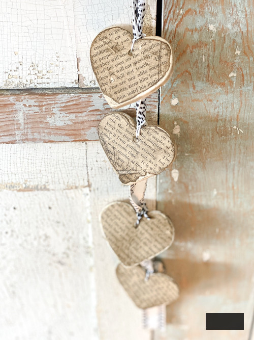 Create a charming DIY Heart Garland using air dry clay, book pages, and stain. This easy craft adds a vintage touch to your home decor for any season.