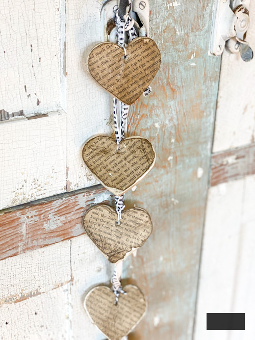 Create a charming DIY Heart Garland using air dry clay, book pages, and stain. This easy craft adds a vintage touch to your home decor for any season.