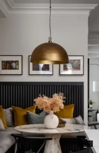 snug corner dining nook with round marble, table, Wishbone-style chairs, mustard and gray velvet cushions, Aged Brass Dome Pendant Light Fixture, wall art frames