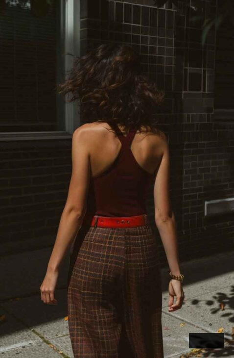 spring dark academia outfit styled with plaid pants and burgundy tank and red belt