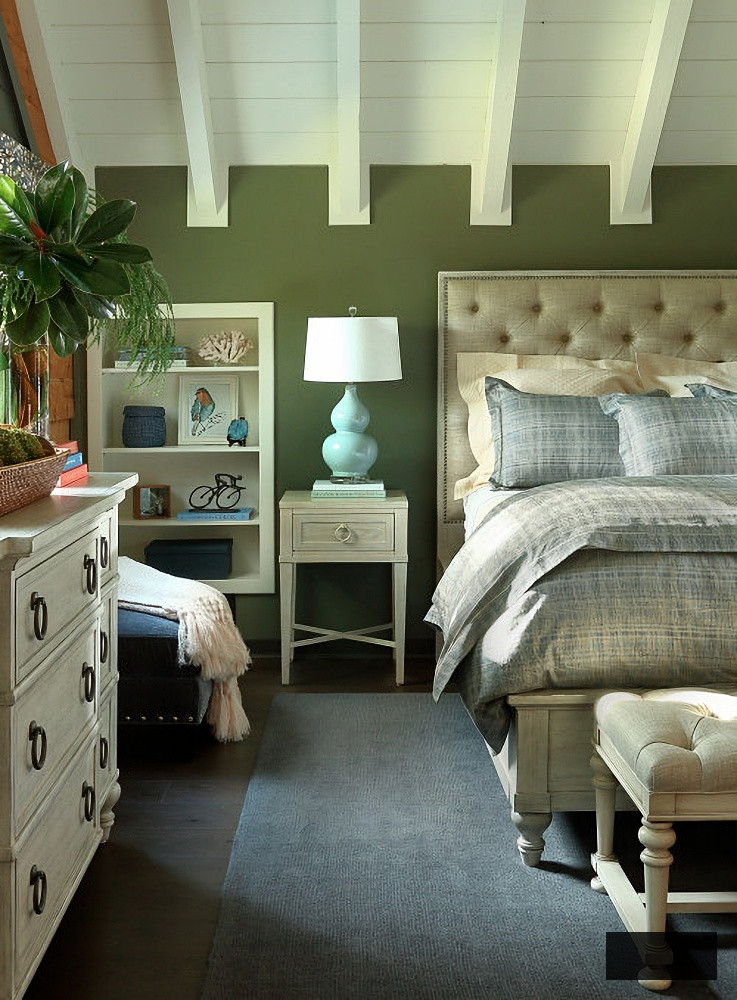 traditional bedroom with green walls and white vaulted ceiling