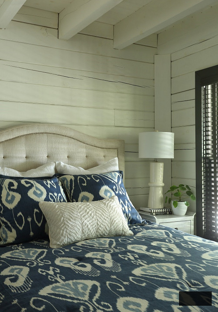 navy geometric print bedspread in renovated log cabin home