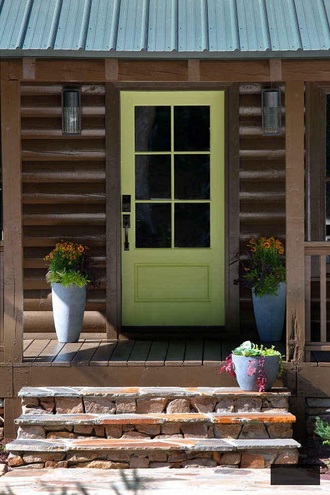 Light green door on log cabin porch
