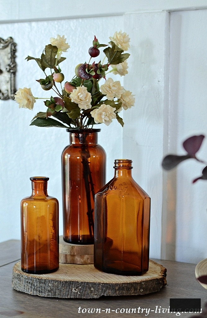 vintage amber bottles in fall vignette