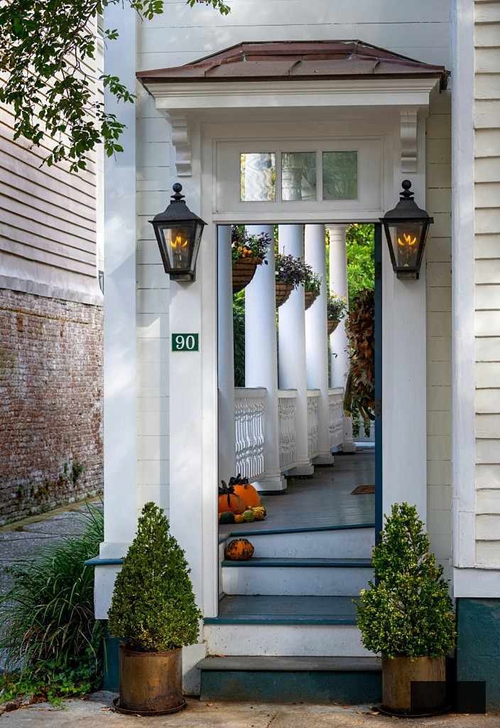 Enclosed porch with small pumpkins peeking out