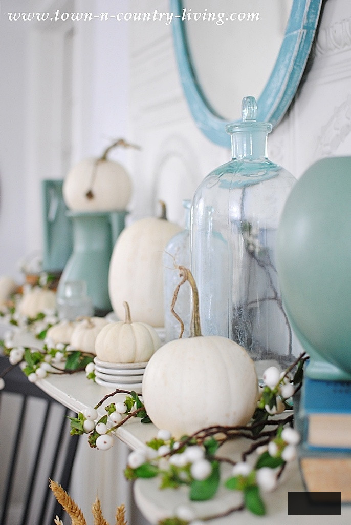 non-traditional fall mantel with baby boos and aqua bottles