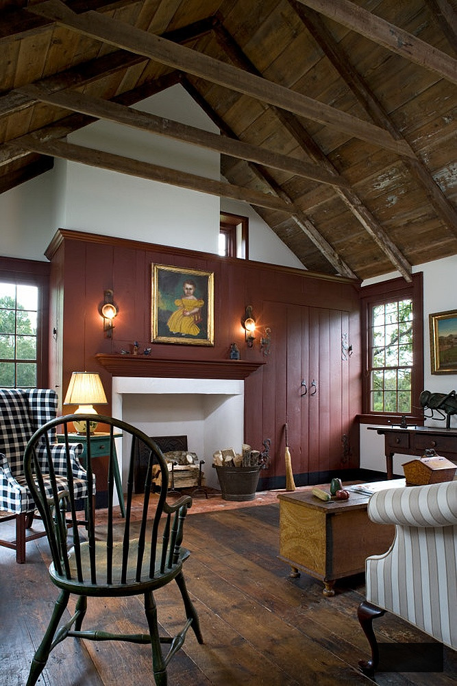 Early American style living room with red wall and fireplace