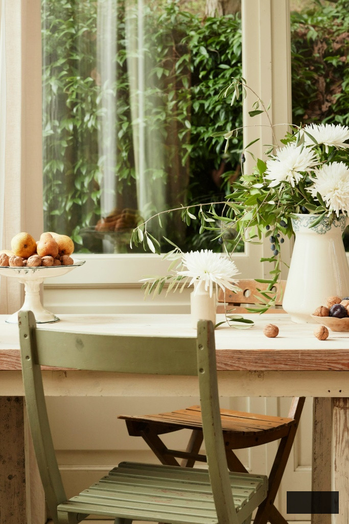simple desk with green chair and bouquet of football mums