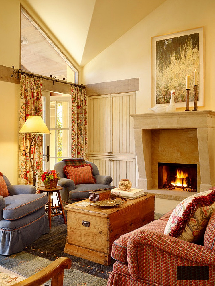 Pale yellow living room with rust couch and stone fireplace