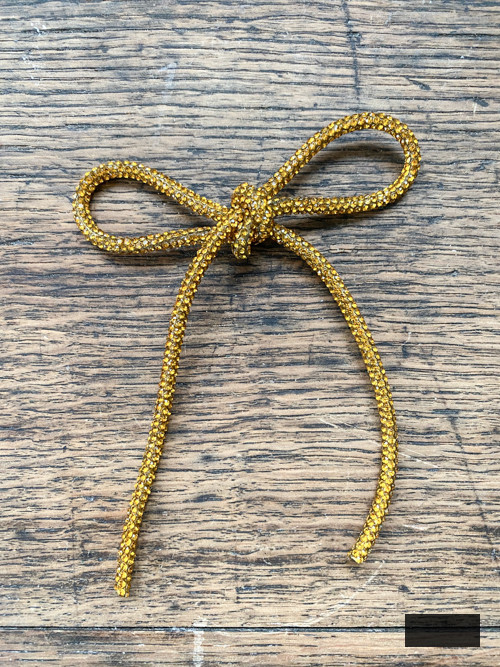 DIY Rhinestone Bow Christmas Ornaments enhance sparkle and charm to your holiday decor. Simple, cost-effective, and perfect for this year's trending bow style!