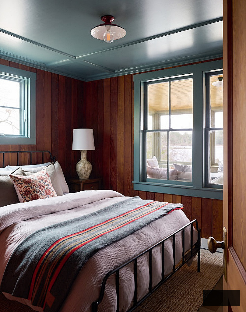 cozy cabin style bedroom with blue ceiling