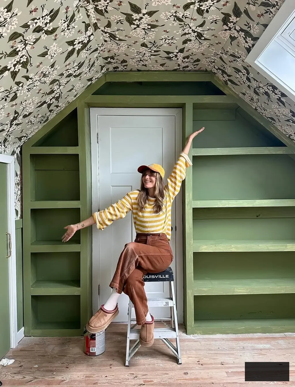 loft bedroom concept featuring avocado green floor-to-ceiling built-in shelving