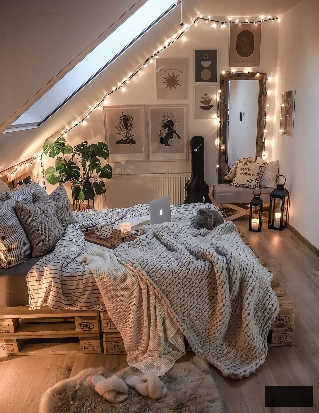 boho, cozy attic bedroom with pallet bed, wall art and string lights